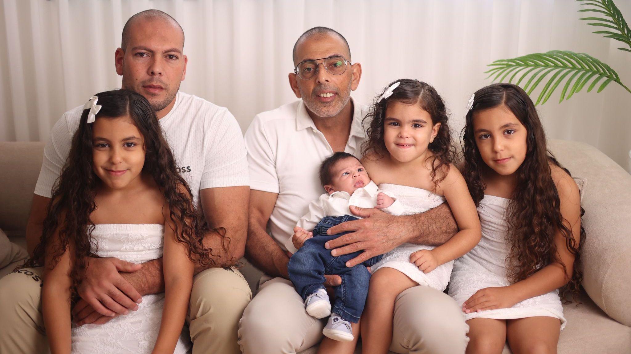 Ziad Samouni (C) with his son Hussein (2nd L) and four children