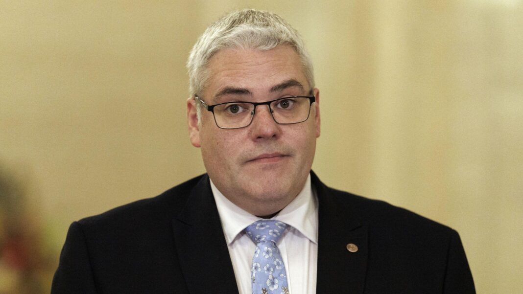It’s within DUP’s gift to remove O’Neill as first minister, says Lockhart DUP leader Gavin Robinson, with short grey hair, wearing glasses, a white shirt, blue tie and black jacket.