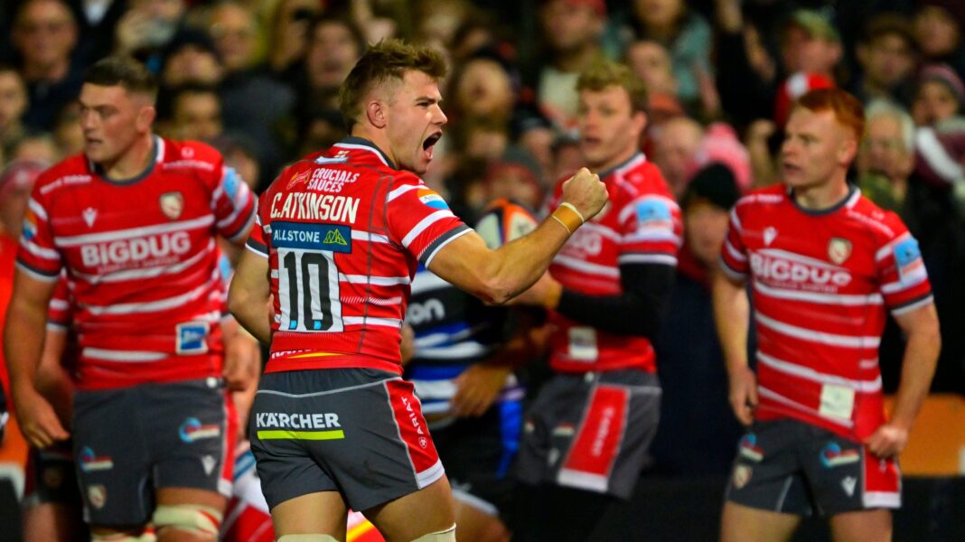 Gloucester have to have belief says Skivington Gloucester players celebrate stopping Bath scoring a try. The Gloucester players are wearing cherry red shirts with thin white horizontal stripes. The player in the middle of the picture is shouting and punching the air in celebration.