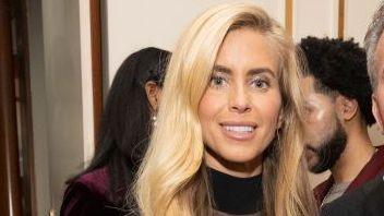 Katie Zacharia with long blonde hair and black turtleneck