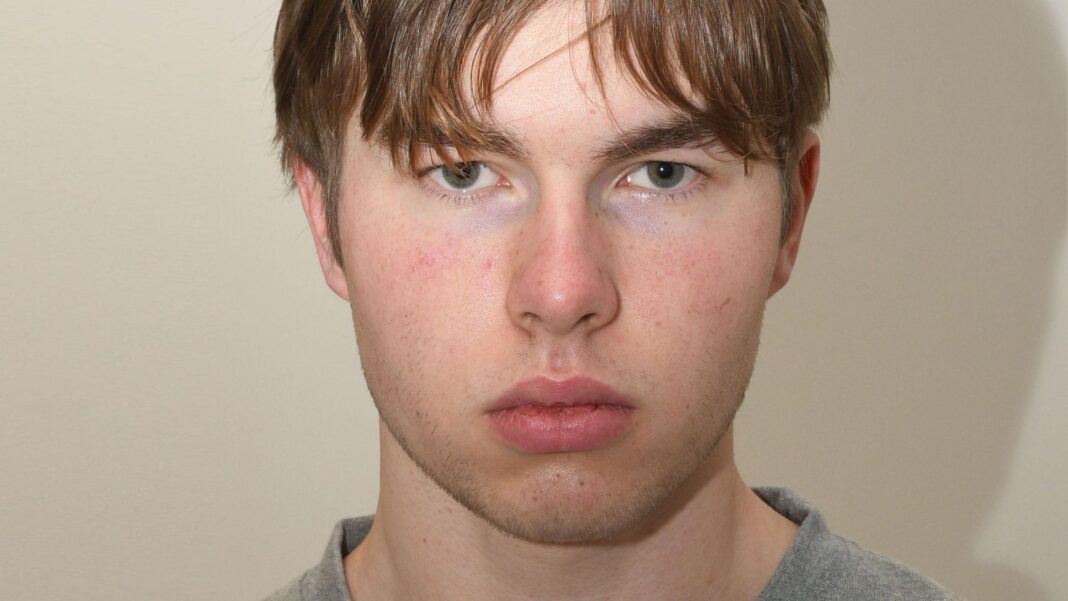 A mugshot of a young man staring at the camera.