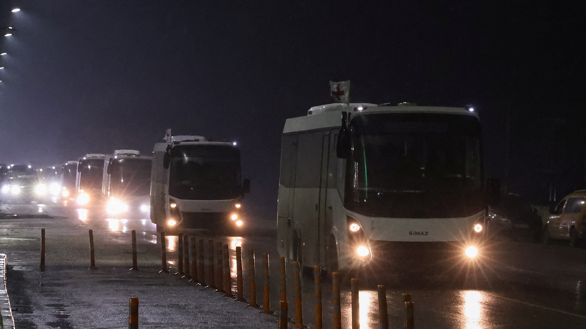 A humanitarian convoy carrying residents evacuated from the Russian-controlled town of Oleshky in Ukraine, drives along a road in Armyansk in Crimea