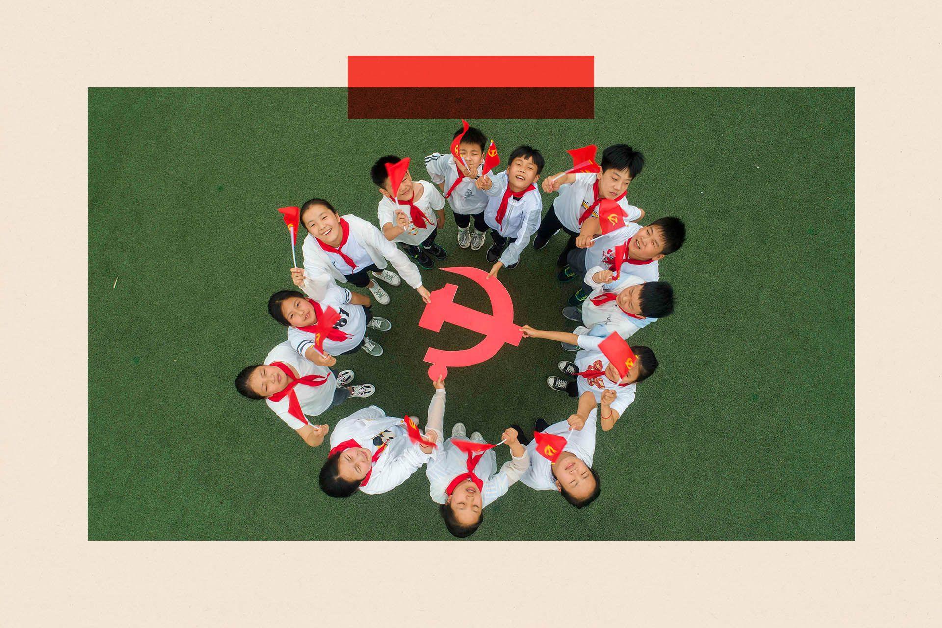 An aerial shot showing a circle of children looking up and holding a hammer and sickle sign