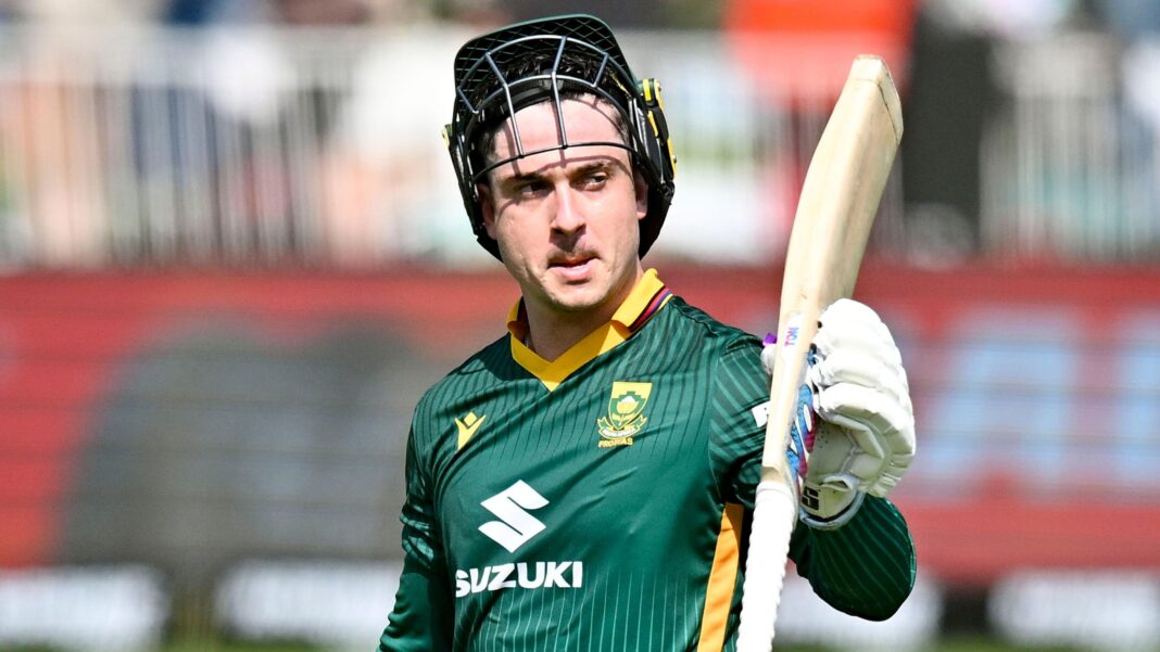 South Africa batter Matthew Breetzke raises his bat, with his helmet placed on his head