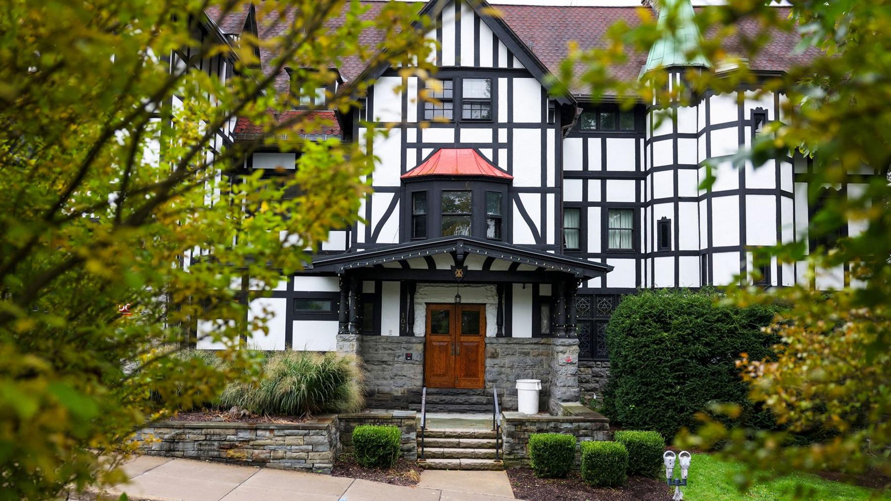 Exterior of Cornell University’s Chi Phi fraternity house showing a white building with mock tudor style black details, in Ithaca, New York, US, September 29, 2026.