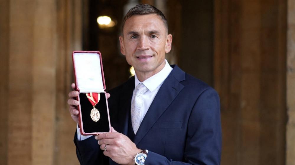 Sir Kevin Sinfield shows off his knights bachelor medal.
