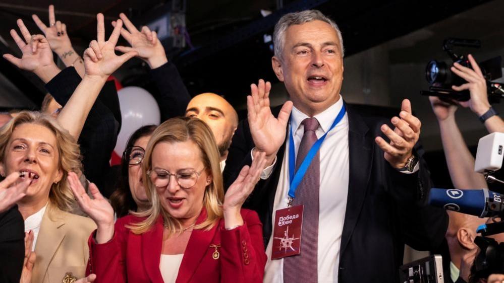 Former Governor of National Bank of Serbia (NBS) and a candidate on the electoral list "Student List - Students Win", Dejan Soskic, celebrates following the first results of the parliamentary election
