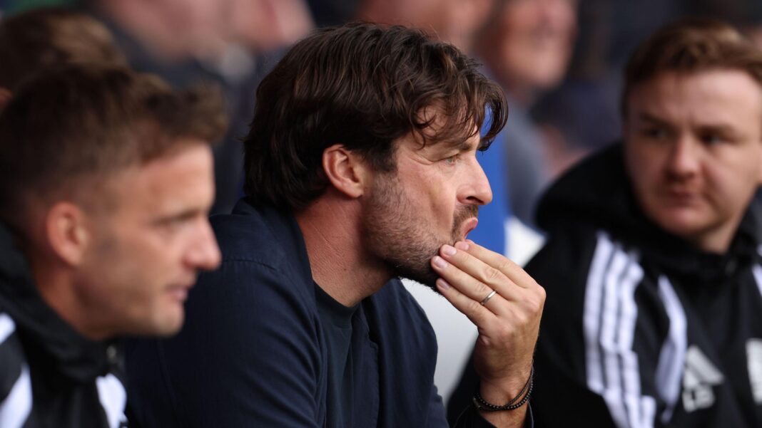 Russell Martin strokes his chin in the Leicester City dugout