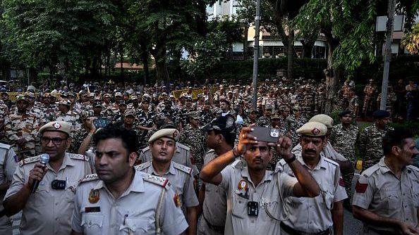 Security personnel stand guard during a protest by India's opposition alliance known as the INDIA bloc in New Delhi on October 7, 2026