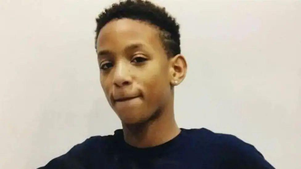 A 14-year-old lad in a dark top looking at the camera