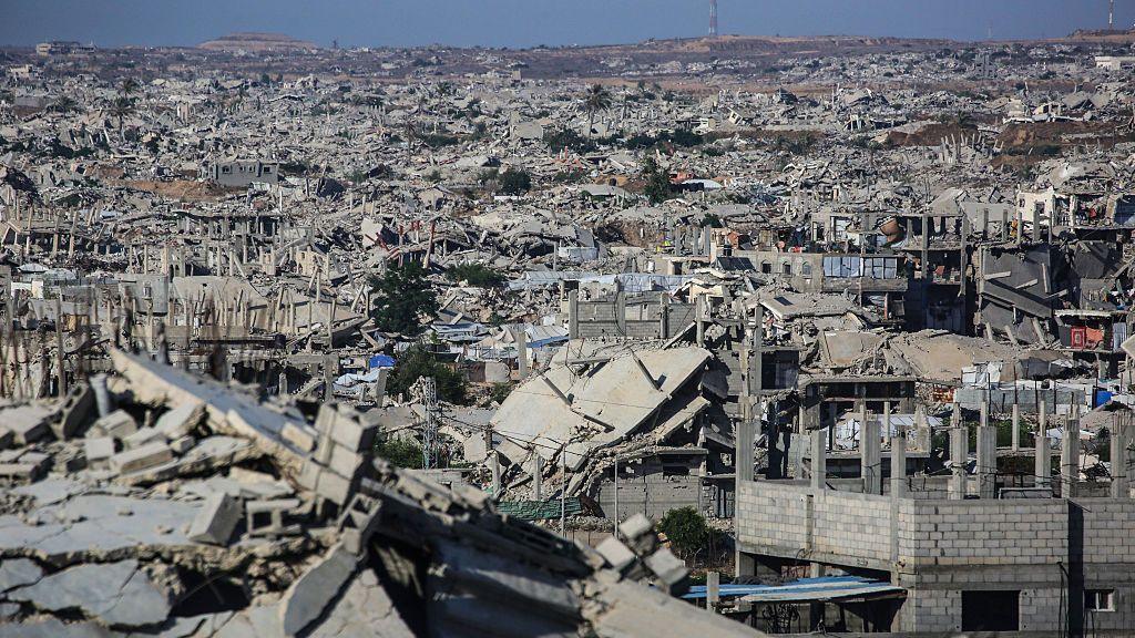 Grey, ruined buildings stretch into the distance.