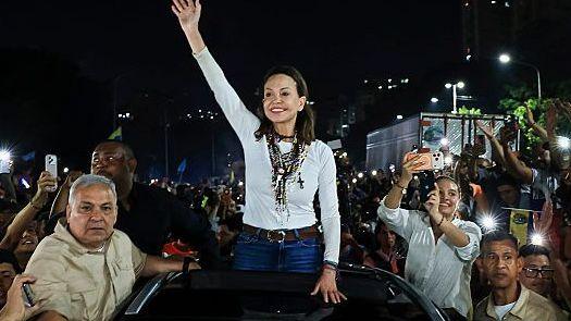 Opposition leader Maria Corina Machado greets the crowd gathered around her vehicle on October 25, 2026 in Caracas, Venezuela
