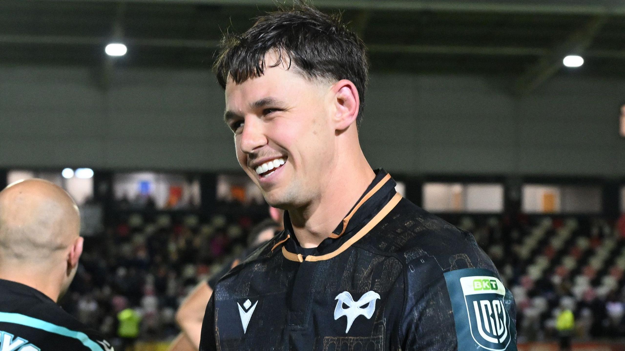 Tom Rogers smiles in an Ospreys jersey after victory against Dragons