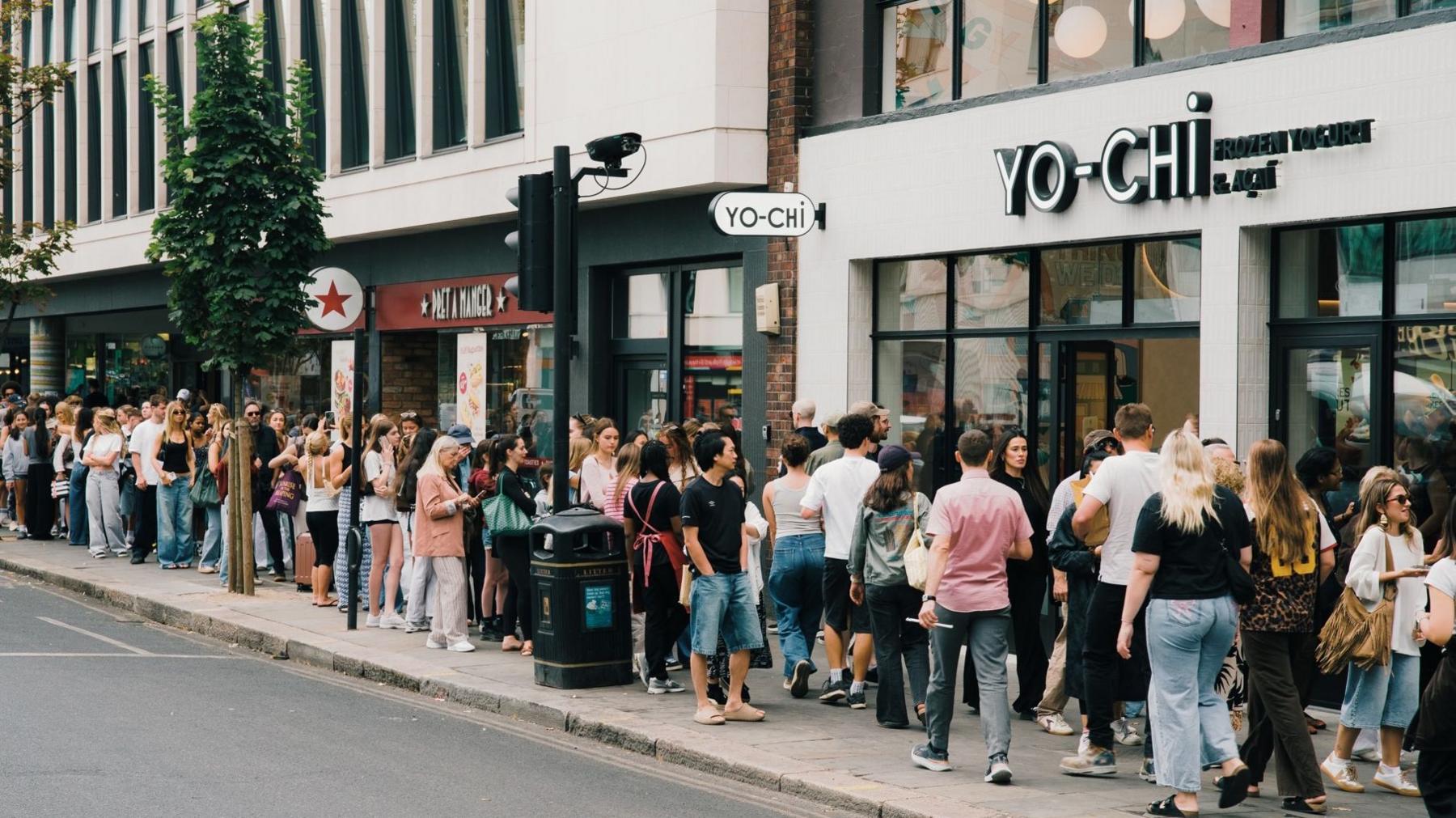 A line of people queueing for frozen yoghurt outside Yo-Chi in central London