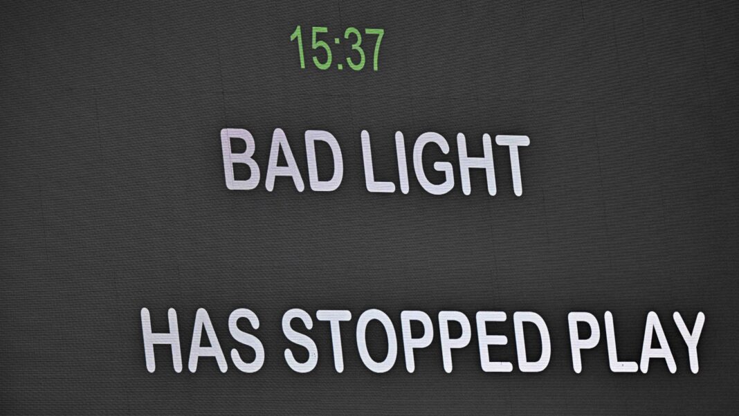 Message telling spectators bad light has stopped play is shown on the big screen