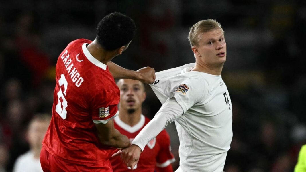 Swansea’s humble approach paying off – Cabango Ben Cabango in red jumps with Erling Haaland in white