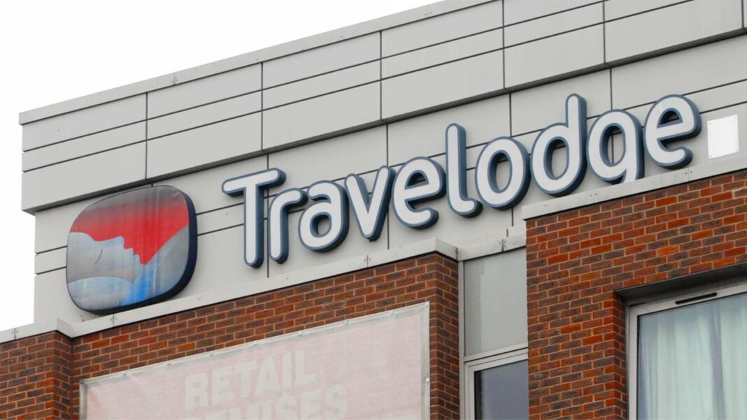 A shot of the Travelodge logo on one of a hotel building.