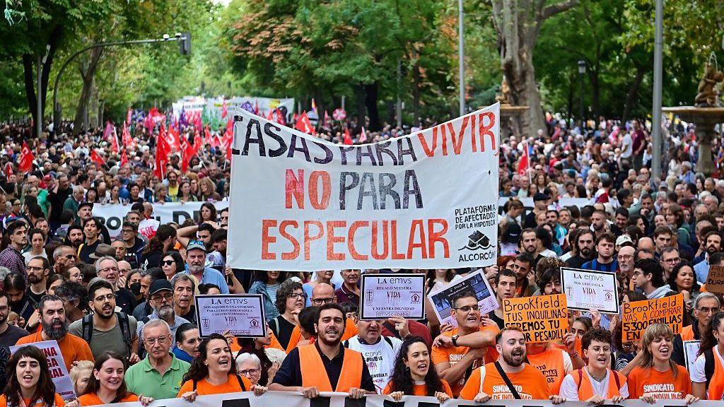 Thousands of people, many wearing orange, participate in a demonstration in Madrid demanding access to affordable housing and protesting against the housing crisis, rising rents, and evictions.
