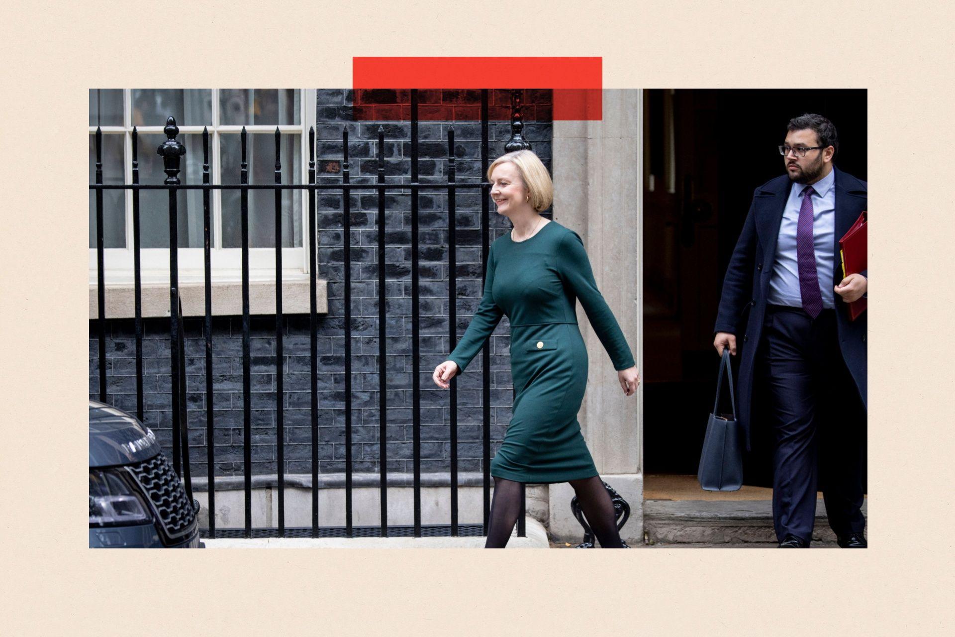 Liz Truss walking in Downing Street. She is wearing a green dress.