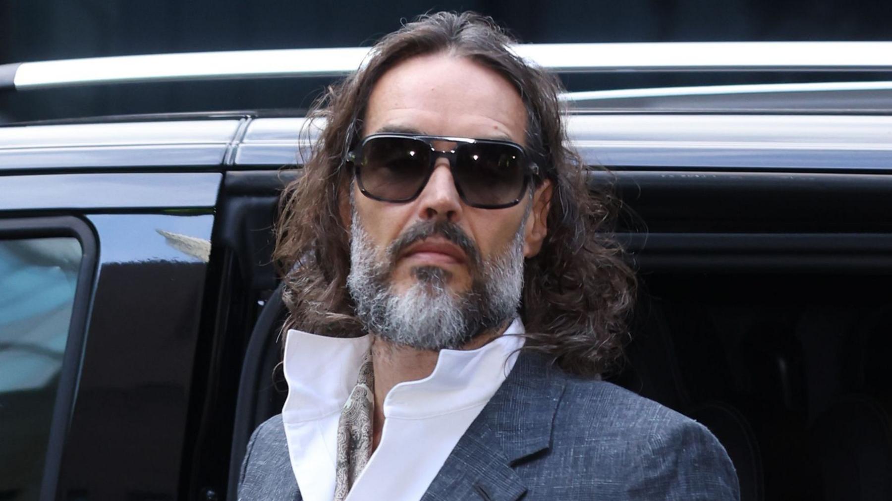 Russell Brand arrives at court ahead of his trial, where he faces rape and sexual assault charges at Southwark Crown Court on October 12, 2026 in London, England