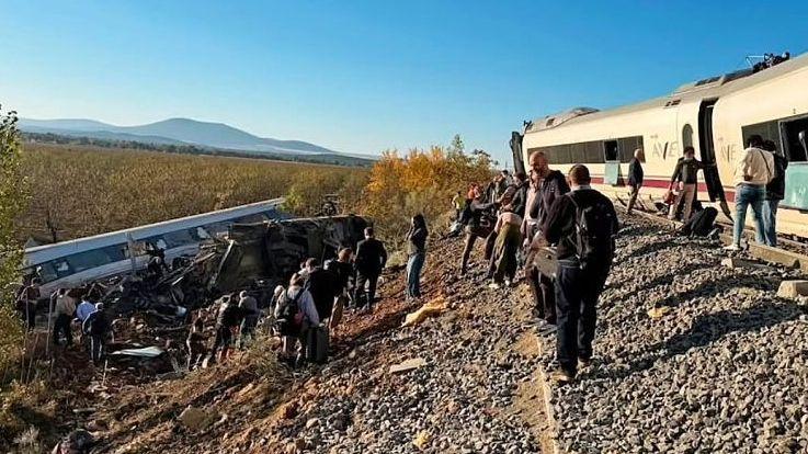 Wide shot showing a derailed train carriage in an embankment