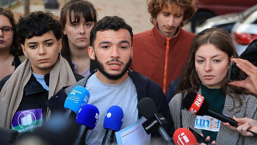 A group of young people speaking to the media