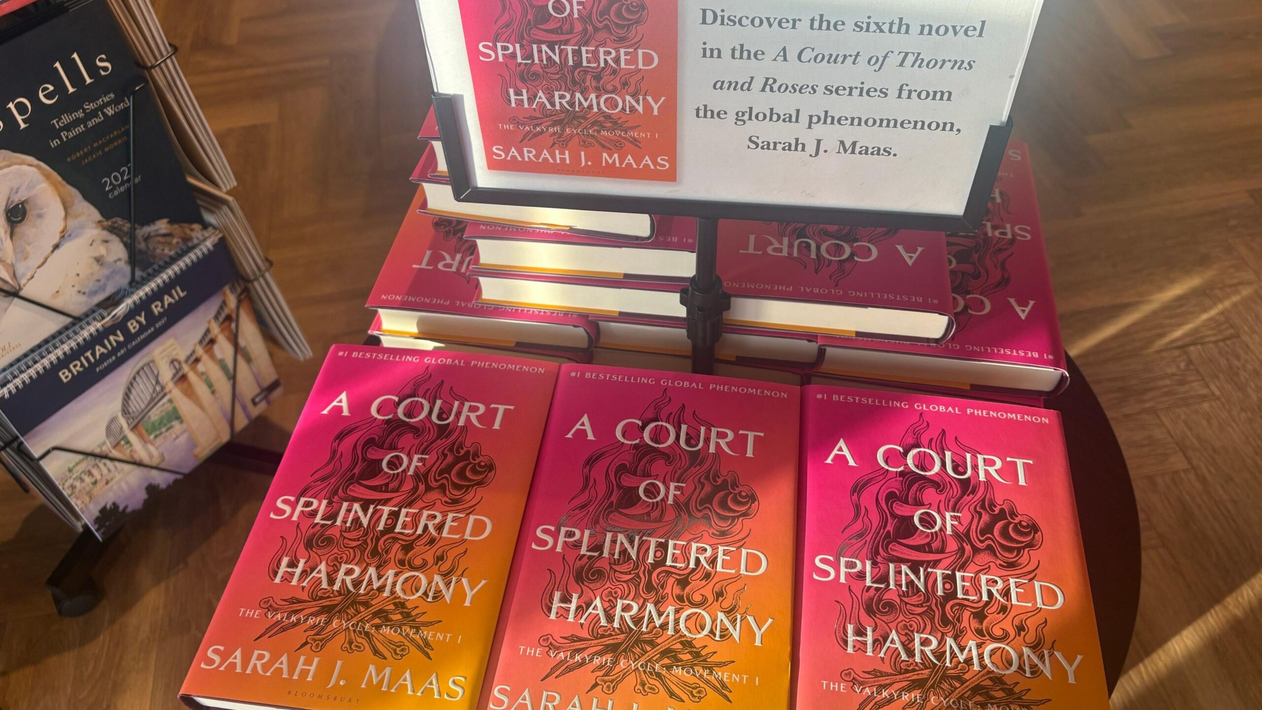 The A Court of Splintered Harmony book on display in a bookshop