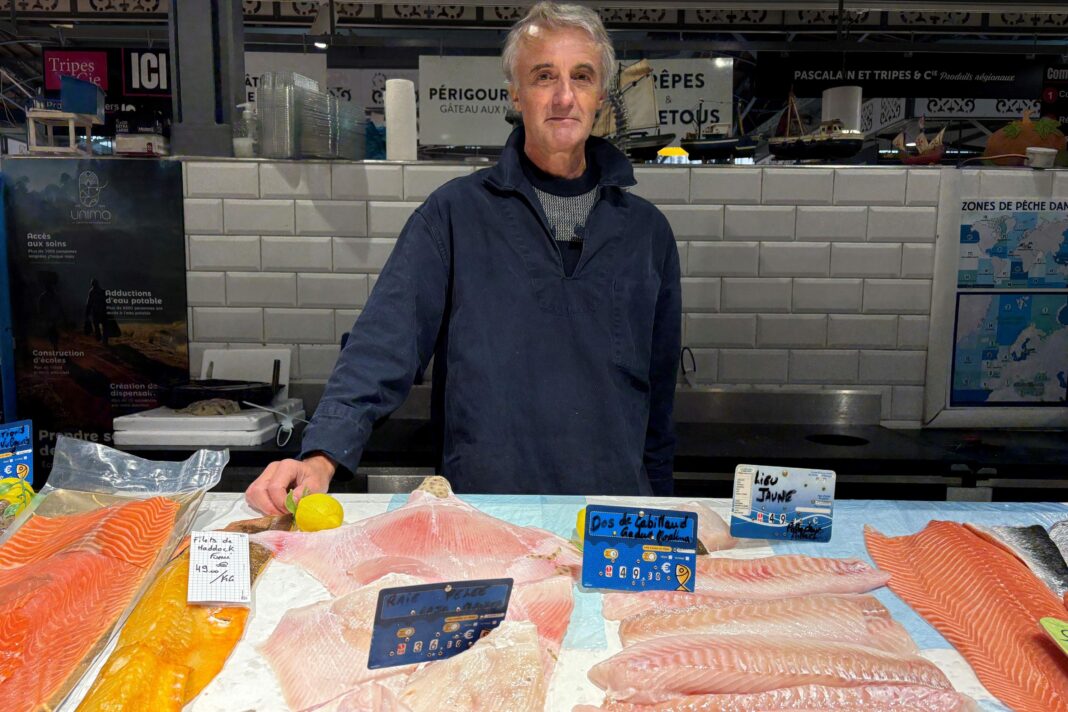 Ruins of Limoges city hall a symbol of France divided by national protests Jean Roger Faucher, a man in his sixties, stands behind his fishmongers stall. Various cuts of fish are in front of him and he wear a navy jacket.
