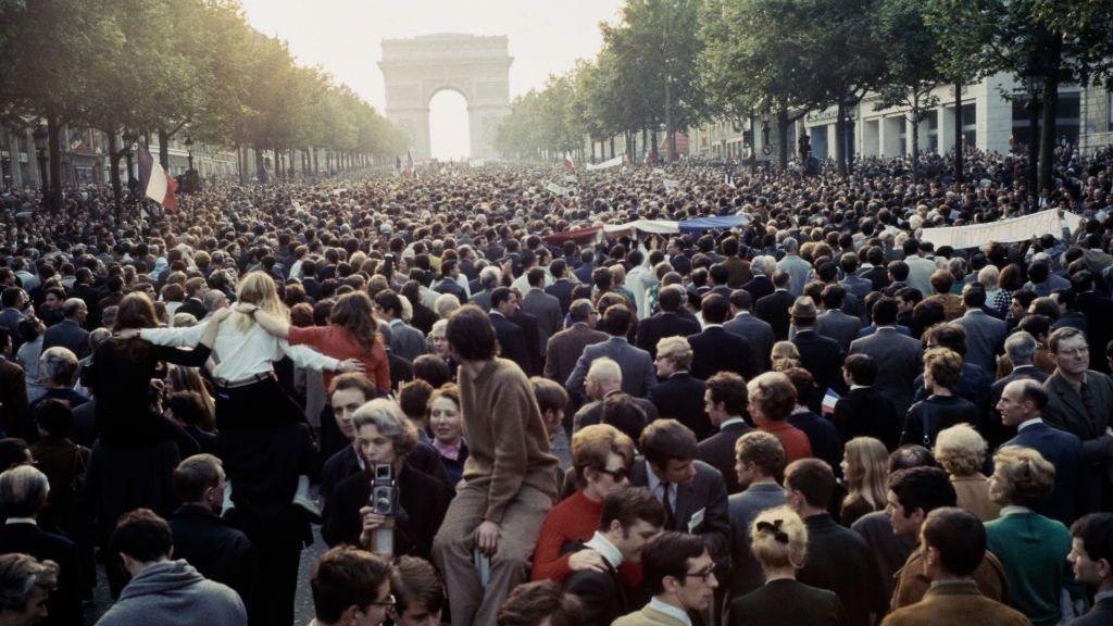 Workers and trade union members march along the Champs-Élysées toward the Arc de Triomphe in central Paris in a mass rally to protest for popular government in 1968.