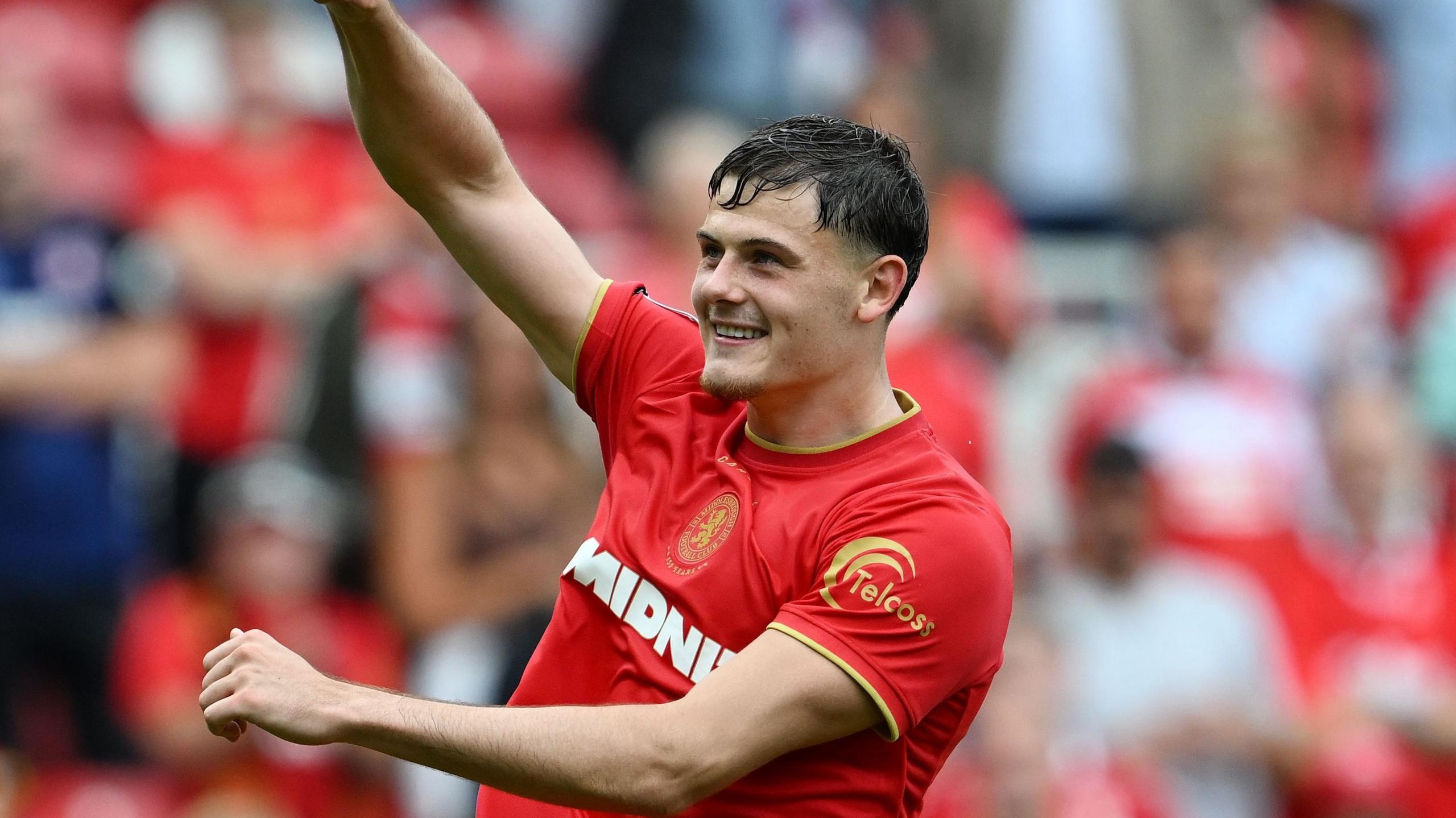 Will Lankshear has a broad smile and his right arm raised aloft after scoring for Middlesbrough at the Riverside Stadium