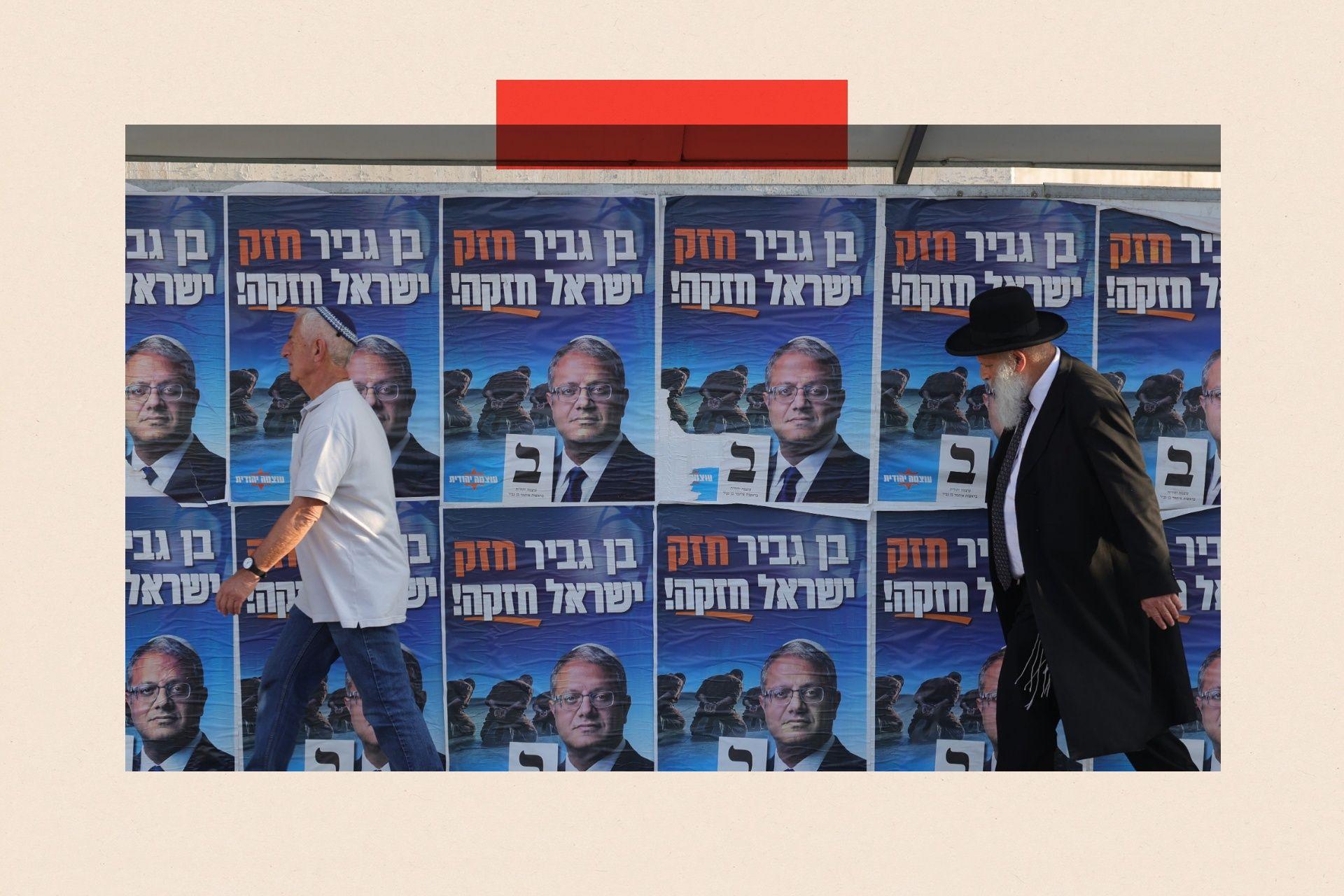 Two men walk past posters bearing Itamar Ben-Gvir's face