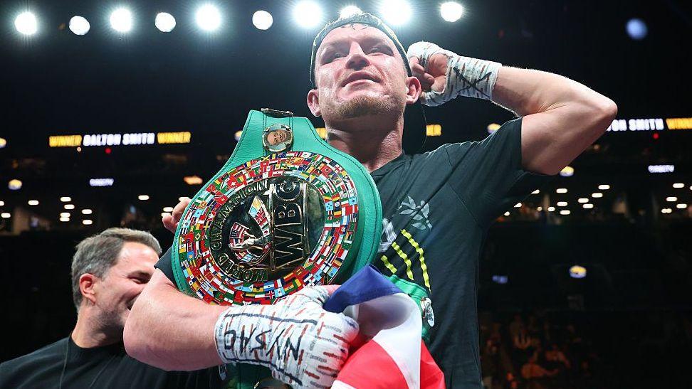 Dalton Smith has the WBC light-welterweight title on his shoulder and is holding up his arm