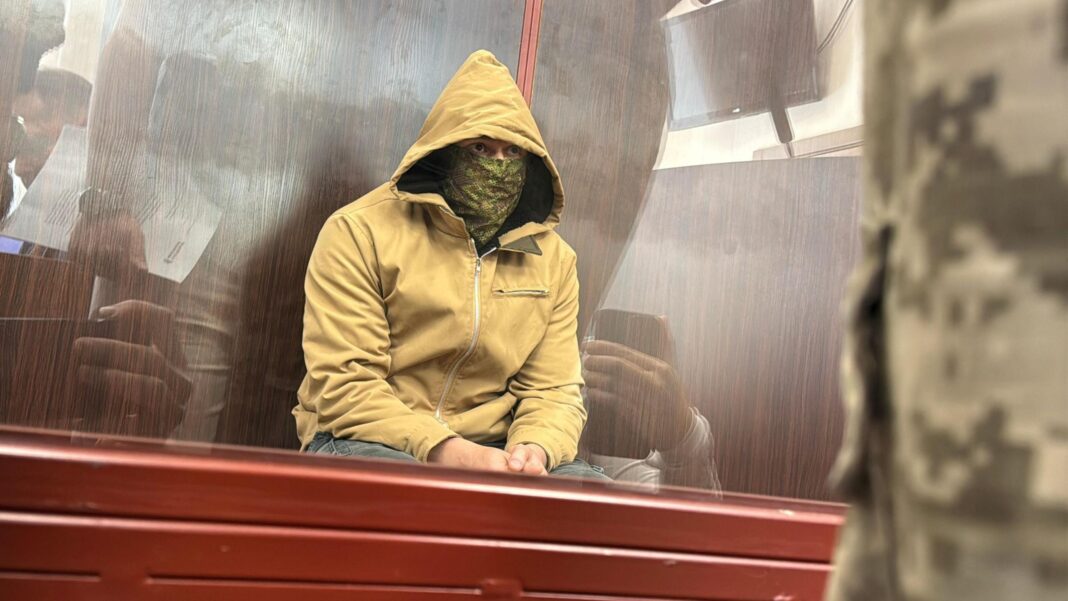 Suspect linked to Monaco bomb attack on millionaire breaks silence to BBC A man sits with a hood on and yellow jacket and face mask