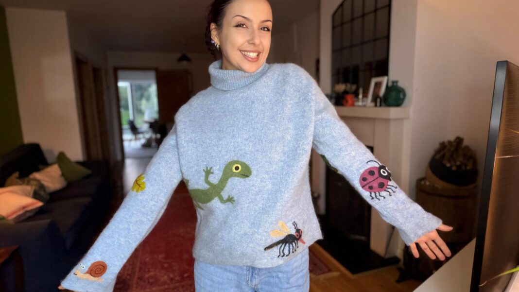 From workshops to the catwalk – why mended clothes are going mainstream Alice Brown, a woman in her living room in a pale blue jumper that features a lizard, a snail and various insects dotted around in unusual places.