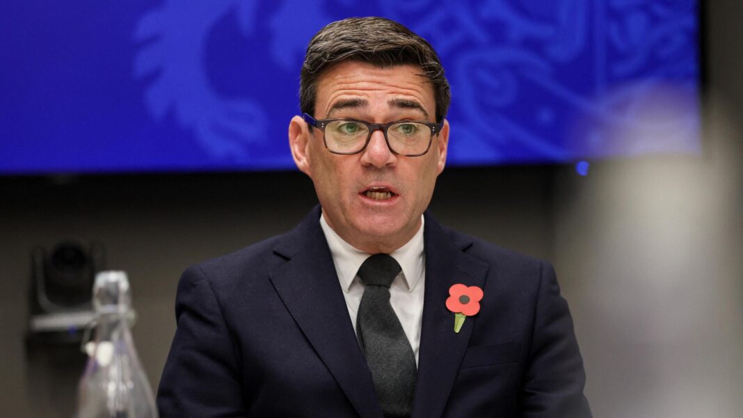 Black Doves actress says she loved playing ‘a very Welsh assassin’ Prime Minister Andy Burnham. He has dark hair and glasses, and is wearing a dark suit, black tie and poppy.