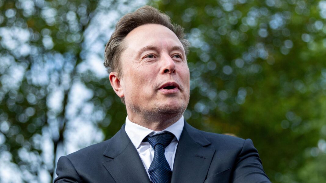 Musk says US government may be behind slowdown of Ukraine drone speeds Elon Musk speaking and looking to the right with leafy green trees in the background.