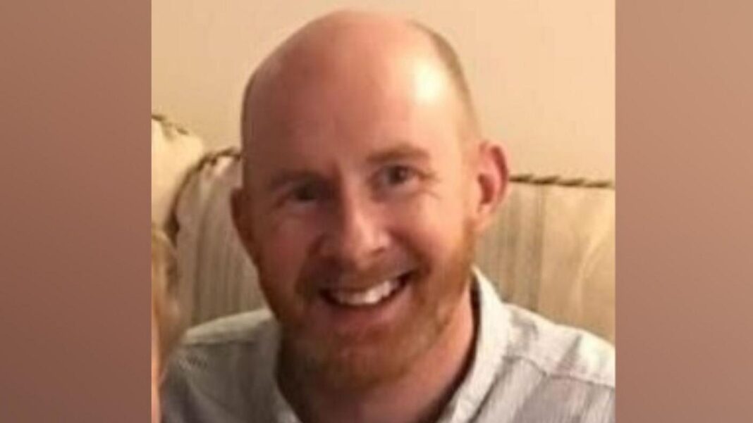 Husband accused of GP murder appears at Crown Court A man smiling at the camera in a head and shoulders image. He has a bald head with very short ginger hair at the sides and a ginger beard. He is wearing a pale blue shirt and sitting on a cream sofa.
