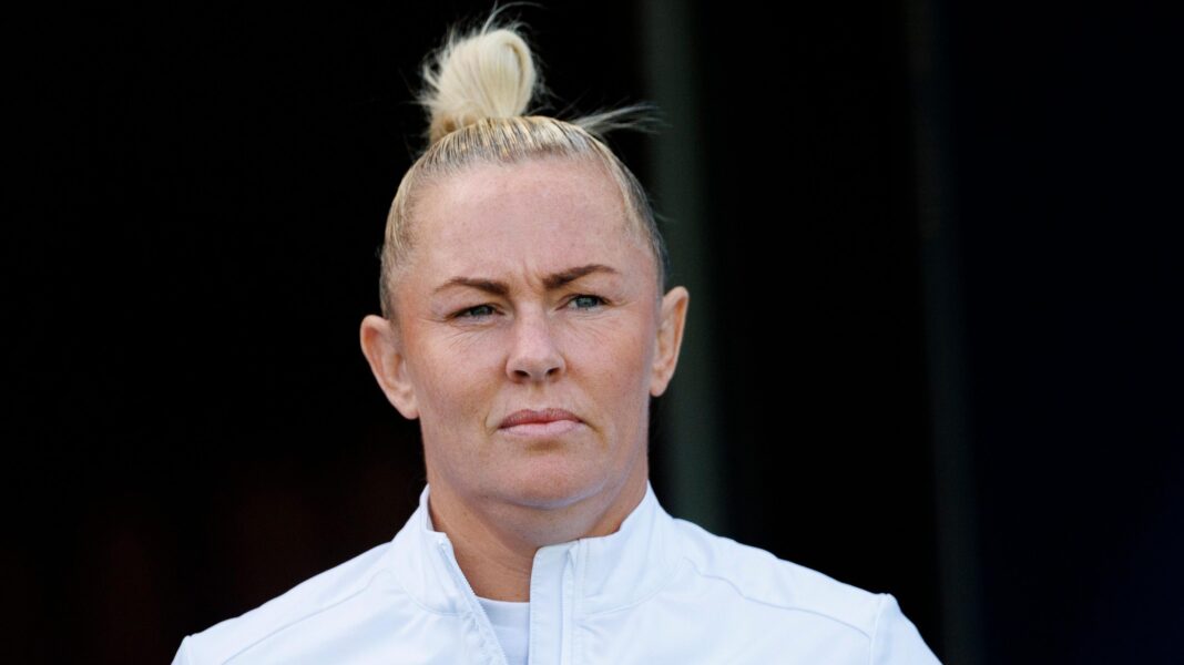 Marlie Packer wearing a white England jacket