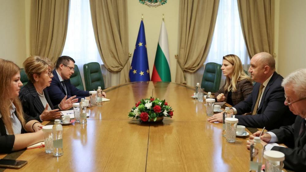 Bulgarian Prime Minister Rumen Radev (sitting in the middle on the right-hand side) speaks to Russian Ambassador to Bulgaria, Eleonora Mitrofanova (sitting in the middle on the left-hand side), during a meeting in Sofia. Photo: 13 October 2027