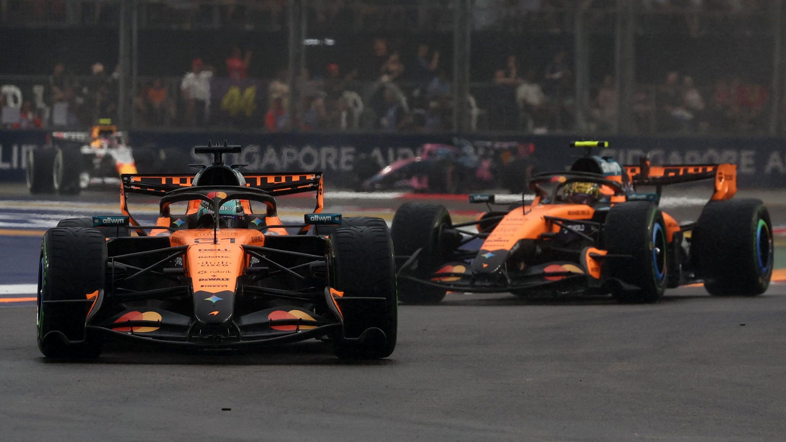 McLaren's Oscar Piastri with team-mate Lando Norris following behind during the Singapore Grand Prix sprint race