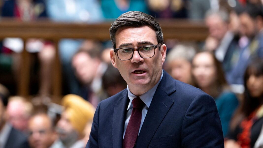 I do not have confidence UK is safe from Russian threats, says Swinney A dark haired man with dark glasses with a dark blue suit with people sitting, out of focus, in the background.