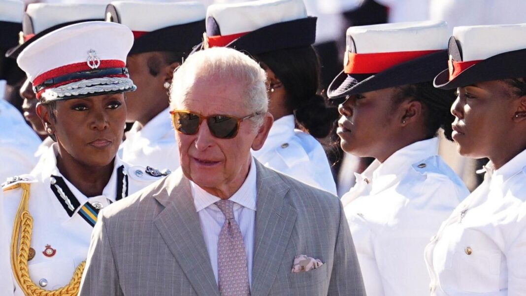 King Charles arrives in Guyana as Bahamas visit declared ‘diplomatic success’ King Charles, wearing sunglasses and a grey suit, smiles as he inspects a Guard of Honour put on by the Royal Bahamian Defence Force.