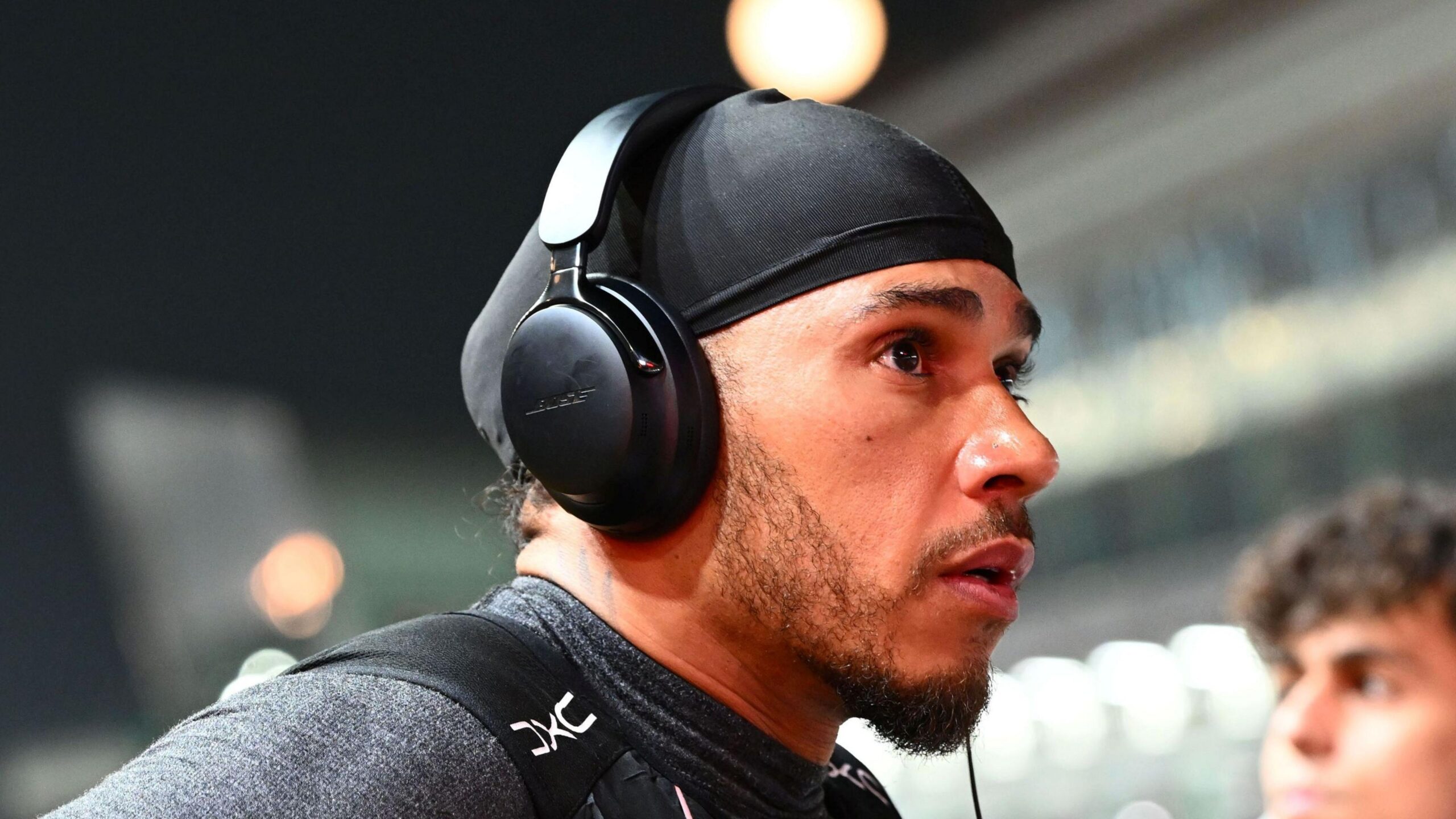 Lewis Hamilton, wearing a pair of headphones, on the grid before the race in Singapore