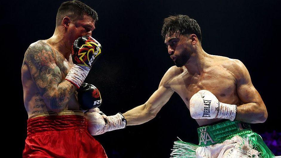 Adam Azim lands a punch on Steve Claggett