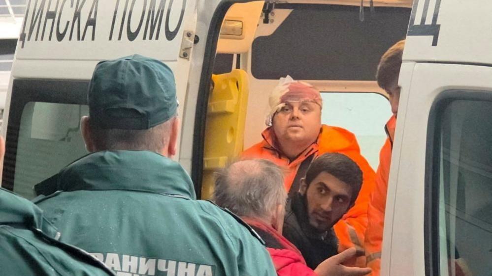 Rescued crew members from a ship that was damaged in drone attack are taken away in an ambulance in Varna, Bulgaria, October 13, 2026.