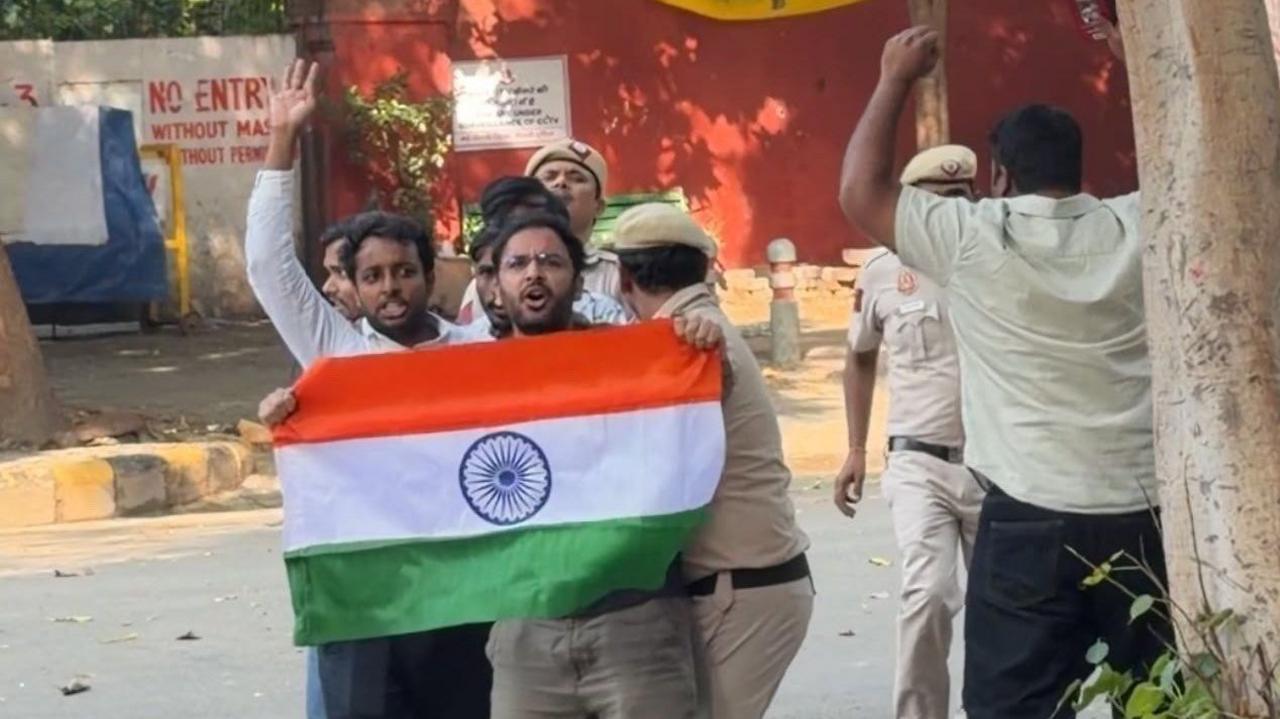 CJP's Ashutosh Ranka seen holding the Indian flag with police dragging him