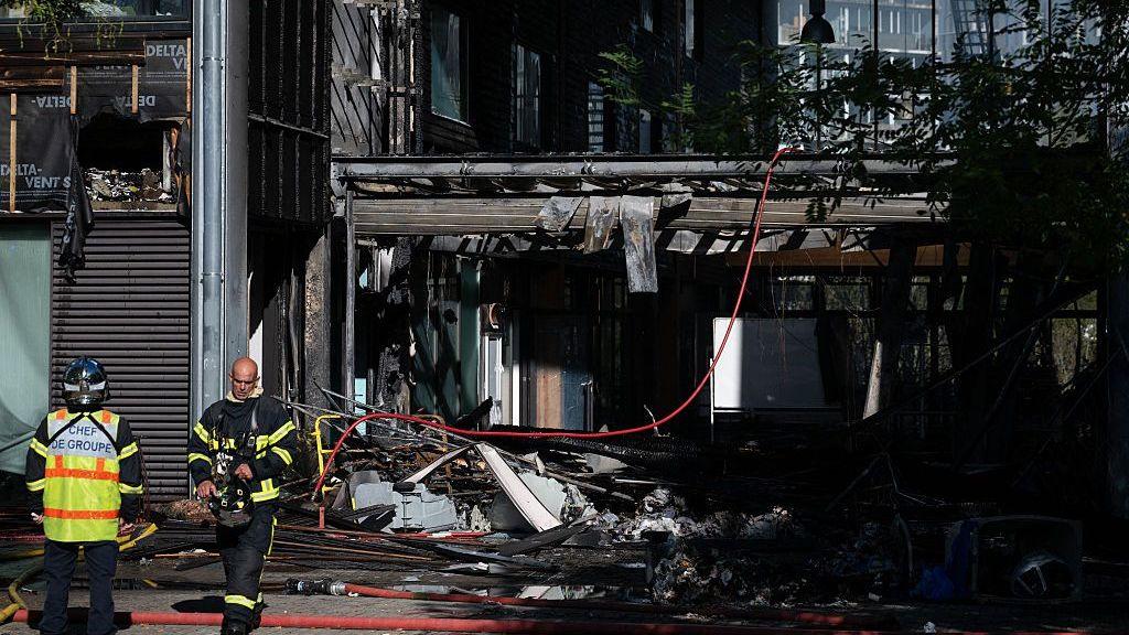 Firefighters manage the damaged entrance hall at Nelson Mandela High School in Nantes, western France on October 1, 2026.