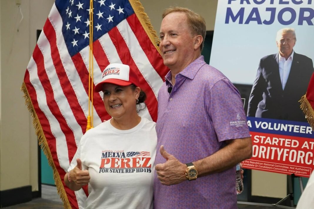 ‘The necktie is dead’: How US midterm candidates are dressing for votes Ken Paxton and a female supporter pose in front of a large US flag and a campaign poster featuring Donald Trump. The woman wears a white campaign T-shirt and red-and-white baseball cap. Paxton wears a purple polo shirt. Both give a thumbs-up gesture.