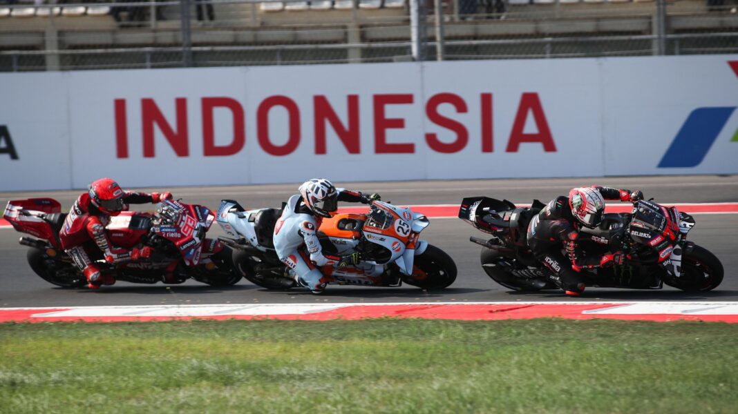 Three riders, including Marco Bezzecchi, take a corner at the Indonesian Grand Prix