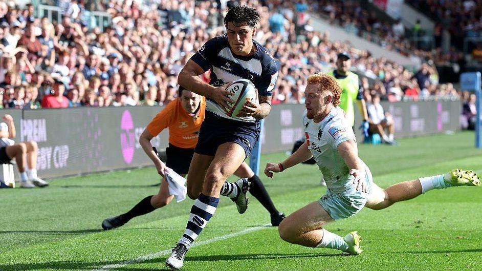 Louis Rees-Zammit eludes a tackle and prepares to touch the ball down for his first try in Prem victory over Northampton Saints